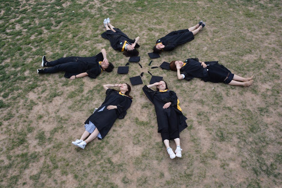 Overhead view of six graduates lying in 