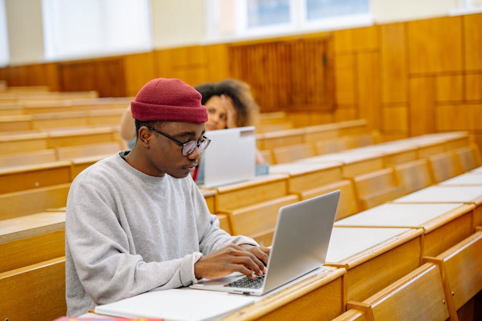 Students focus on laptops in a spacious 